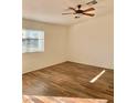 Bright bedroom with wood-look floors, large windows for natural light, and ceiling fan at 2050 N Los Feliz St # 114, Las Vegas, NV 89156