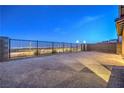 View of the backyard with city view, stone landscaping, and iron fence at 2194 Pigeon Hawk St, Las Vegas, NV 89138