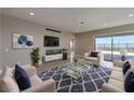 Open living room with city views, modern furniture, and a large area rug at 2194 Pigeon Hawk St, Las Vegas, NV 89138