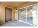 Private patio area with textured walls features sliding glass door entry to living space at 2200 S Fort Apache Rd # 2049, Las Vegas, NV 89117