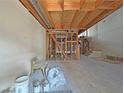 Unfinished basement showing the construction framing and plumbing, and ready for customization at 2471 Old Forge Ln # 103, Las Vegas, NV 89121