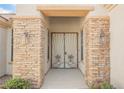 Inviting front entry with decorative security doors, sconces and attractive stone pillars at 3004 Canton Hills St, Henderson, NV 89052