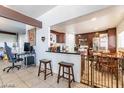 Open kitchen with breakfast bar and a view into living areas at 304 S Crestline Dr, Las Vegas, NV 89107