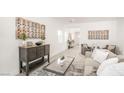 Open-concept living room with stylish furniture, artwork, and a seamless flow to other areas at 3915 Wesvan Ct, Las Vegas, NV 89121