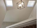 Open stairway with modern lighting fixtures and bright skylights at 4356 Pittsfield St, Las Vegas, NV 89115