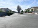 A tranquil street view of well-maintained homes, green lawns, and tidy landscaping under a bright sunny sky at 4356 Pittsfield St, Las Vegas, NV 89115