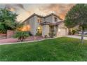Beautiful two-story home with manicured lawn, desert landscaping, and a welcoming entrance at 4573 Milvio Ave, Las Vegas, NV 89141