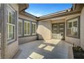 Enclosed front courtyard with double doors, large windows, and tile flooring at 4574 Fiore Bella Blvd, Las Vegas, NV 89135