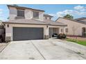 Lovely two-story home with a two-car garage, manicured lawn, and inviting front porch at 5220 Remini Ct, Las Vegas, NV 89130