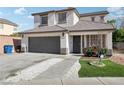Beautiful two-story house with two car garage, stone walkway, and vibrant flower bed at 5220 Remini Ct, Las Vegas, NV 89130