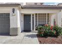 Inviting front porch with a 'Welcome' sign, cozy seating, and colorful floral accents at 5220 Remini Ct, Las Vegas, NV 89130