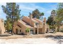 Exterior view of a home featuring balconies, a tile roof, and a low-maintenance yard, perfect for outdoor enjoyment at 5329 La Patera Ln, Las Vegas, NV 89149