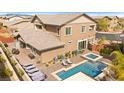Aerial view of a home's backyard featuring a swimming pool, spa, and lounging area at 5523 Kyle Peak Ct, Las Vegas, NV 89135