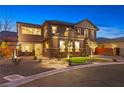 Charming two-story home with stone accents, manicured landscaping, and inviting walkway at 5523 Kyle Peak Ct, Las Vegas, NV 89135
