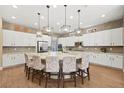 Modern kitchen with a large island, pendant lighting, and stainless steel appliances at 5523 Kyle Peak Ct, Las Vegas, NV 89135