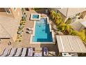 Aerial view of a backyard with a pool, spa, lounge chairs, and covered patio area at 5523 Kyle Peak Ct, Las Vegas, NV 89135