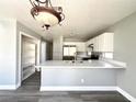 Bright kitchen featuring stainless steel appliances, modern cabinetry, and an eat-in breakfast bar at 5720 Ruby Creek Dr, Las Vegas, NV 89142