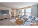 Comfortable living room featuring natural light, a cozy sectional, and modern accents for a stylish space at 6112 Aster Garden St # 131, North Las Vegas, NV 89081