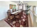 Formal dining room features a beautiful rug and large windows for natural light at 66 John Stuart Mill St, Henderson, NV 89002