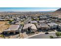 Expansive aerial view of a luxury home nestled in a vibrant community with stunning mountain and city views at 6832 Apogee Ridge Ct, Las Vegas, NV 89135