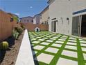 Landscaped backyard featuring pavers and turf, offering a low-maintenance outdoor space at 6837 Crimson Lily St, Las Vegas, NV 89139