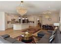 Open-concept living space featuring modern light fixtures, furnishings, and hardwood floors at 6837 Crimson Lily St, Las Vegas, NV 89139