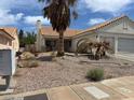 Single-story stucco home featuring desert landscaping and two-car garage at 693 W Pacific Ave, Henderson, NV 89002