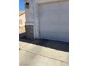 Close-up of a two-car garage door with peeling stucco at 693 W Pacific Ave, Henderson, NV 89002