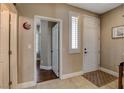 Hallway featuring tile floors, a large closet, and a view of an adjacent bedroom or office at 8022 Severn Valley St, Las Vegas, NV 89139