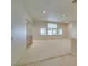 Spacious living room with neutral carpet, recessed lighting, and bright natural light at 8404 Dripping Rock Ct, Las Vegas, NV 89131