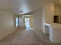 Spacious living room with carpet flooring, neutral paint, and a view of the front yard at 8616 Hidden Pines Ave, Las Vegas, NV 89143