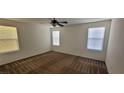 Spacious bedroom with neutral walls, carpet, ceiling fan, and bright natural light from three windows at 8626 Anderson Dale Ave, Las Vegas, NV 89178