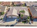 Stunning aerial view of the home showcasing its desert landscaping, three-car garage, and immaculate desert landscaping at 904 Rhyolite Ter, Henderson, NV 89011