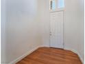 Minimalist entryway with wood floors and a white front door at 9812 Turtle Walk Ave, Las Vegas, NV 89149
