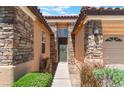 Close up of front door with a stone veneer and desert landscaping at 9812 Turtle Walk Ave, Las Vegas, NV 89149