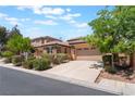 Single-story home with a three-car garage and manicured landscaping at 9812 Turtle Walk Ave, Las Vegas, NV 89149