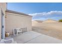 View of empty backyard space with concrete patio, block wall, and low-maintenance gravel landscaping at , Las Vegas, NV 89130
