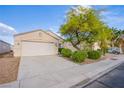 Inviting single-story home showcasing a two-car garage and well-maintained desert landscaping at , Las Vegas, NV 89130