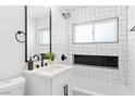 Beautiful bathroom showcasing white subway tile, stylish vanity, and modern black fixtures at 1020 Baker Ave, Las Vegas, NV 89108