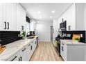 Modern kitchen featuring white cabinets, sleek black hardware, and stunning countertops at 1020 Baker Ave, Las Vegas, NV 89108