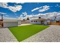 Spacious backyard featuring a grassy area, gravel landscaping, and a storage shed at 108 Prince Ln, Las Vegas, NV 89110