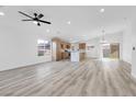 Bright and open living room features modern flooring, recessed lighting, and a ceiling fan at 116 Crescent Bay St, Henderson, NV 89012
