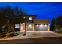 Modern two-story home featuring a three-car garage and well-lit driveway at 12355 Grey Dunes Ave, Las Vegas, NV 89138