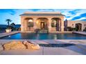 Backyard pool with integrated water feature set in a decorative desert landscape at 1259 N Hollywood Blvd, Las Vegas, NV 89110