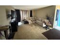 Cozy living room with neutral carpet, comfortable seating, and ample natural light at 1455 E Katie Ave # L23, Las Vegas, NV 89119