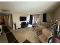 Inviting living room featuring plush carpet and a large window for natural light at 1455 E Katie Ave # L23, Las Vegas, NV 89119