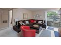 Comfortable living room with a brown sectional sofa, bright accent chair, and sliding glass doors to a balcony at 2120 Ramrod Ave # 513, Henderson, NV 89014