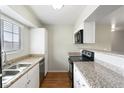 Functional kitchen featuring granite countertops, stainless steel sink, and essential appliances at 2750 S Durango Dr # 2061, Las Vegas, NV 89117