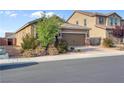 Attractive single-level home with a two-car garage, complemented by lush shrubs and a well-maintained yard at 2924 Duverney Ave, Henderson, NV 89044