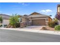 Inviting single-story home with a two-car garage, stone accents, and mature landscaping for added curb appeal at 2924 Duverney Ave, Henderson, NV 89044